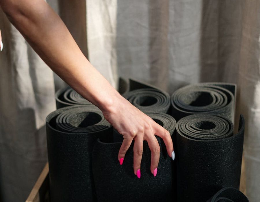 Gym equipment and a yoga mat on a dark background.